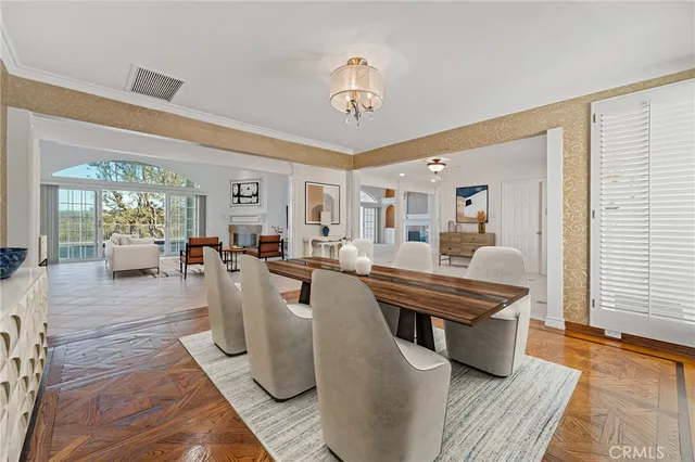 a dining room with furniture a rug and a chandelier