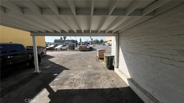 a view of a street with cars parked
