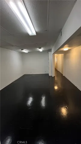 an empty room with wooden floor