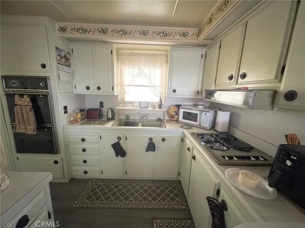 a kitchen with stainless steel appliances a stove a sink and a refrigerator