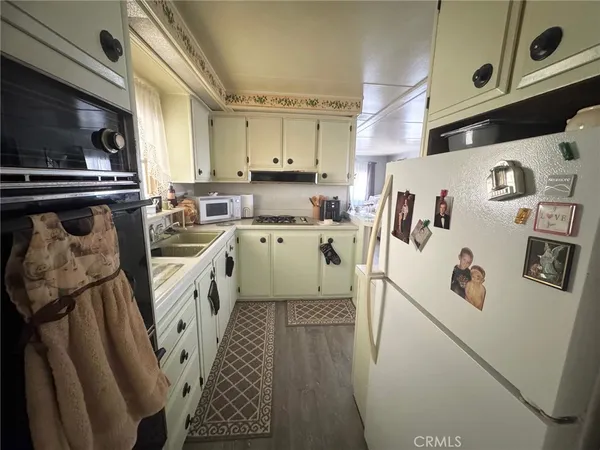 a kitchen with a refrigerator a sink and cabinets
