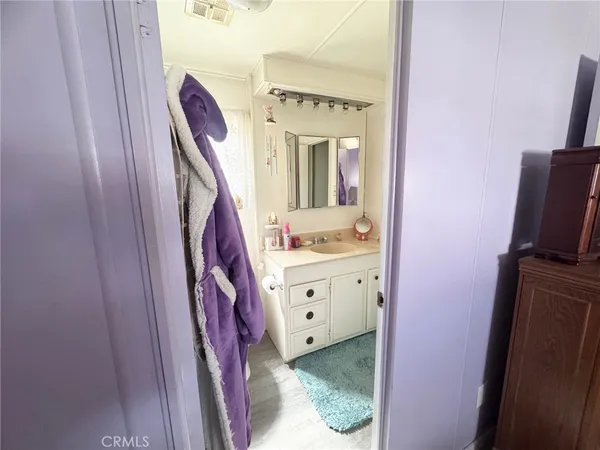 a spacious bathroom with a sink a mirror and a shower