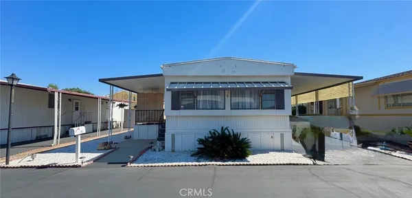 a front view of a house with basket ball court