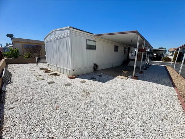 a backyard of a house with basket ball court