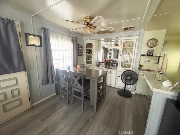a view of a dining room with furniture window and wooden floor