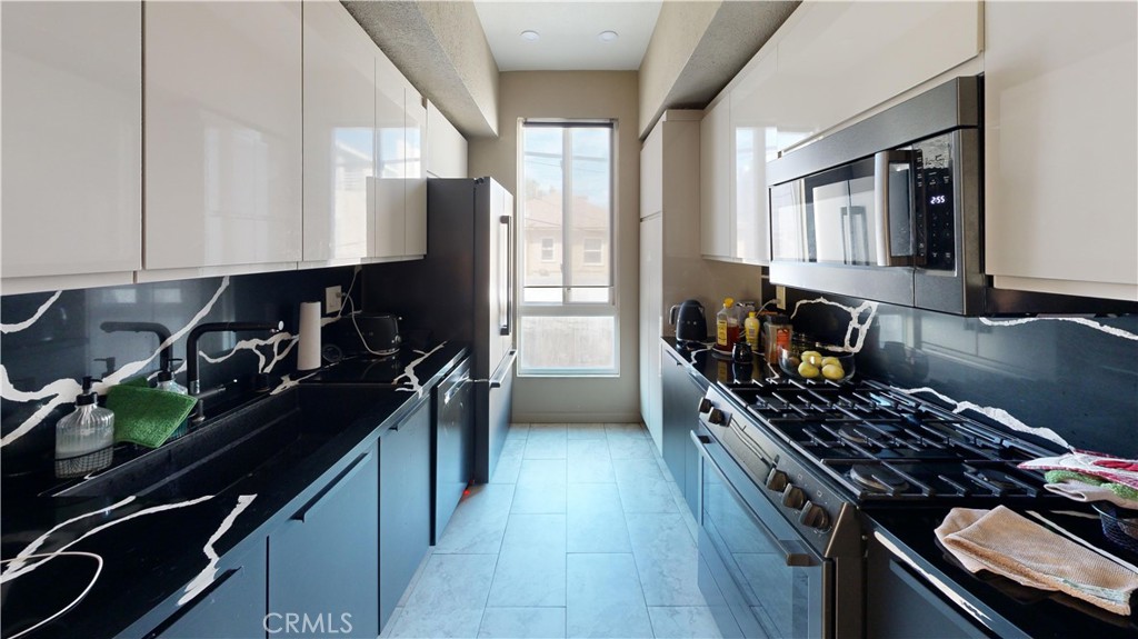 14569 Benefit Street, Unit 102 Sherman Oaks, CA 91403 - Photo 12 of 24 a kitchen with a stove a sink and a window
