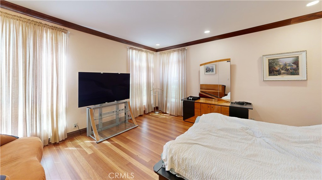 14569 Benefit Street, Unit 102 Sherman Oaks, CA 91403 - Photo 17 of 24 a bedroom with a bed and a flat screen tv