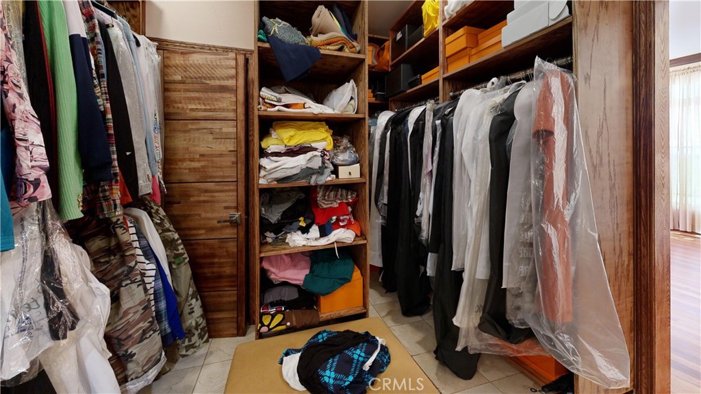 14569 Benefit Street, Unit 102 Sherman Oaks, CA 91403 - Photo 18 of 24 a view of walk in closet with clothes and shoes