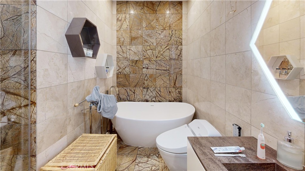 14569 Benefit Street, Unit 102 Sherman Oaks, CA 91403 - Photo 19 of 24 a bathroom with a toilet and a shower