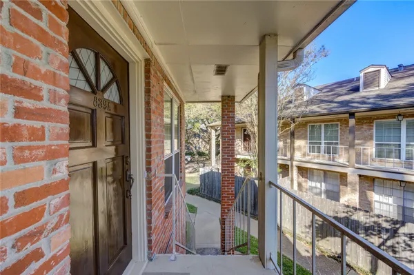 a view of balcony with wooden floor and fence