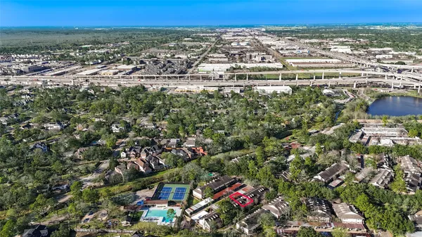 an aerial view of a city with lots of residential buildings and green space