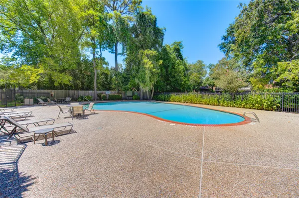 a view of a swimming pool with an outdoor space and seating area