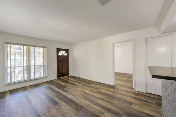 a view of an empty room and wooden floor