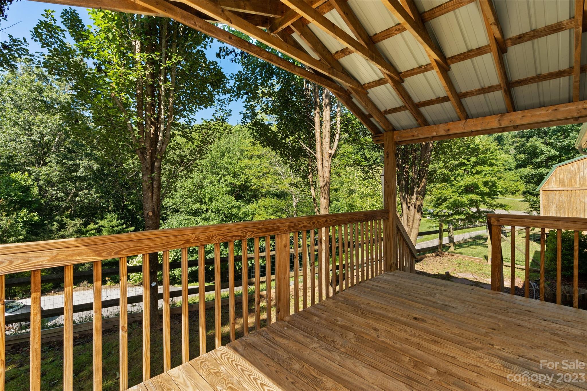 100 Lansing Road Waynesville, NC 28786 - Photo 2 of 11 a view of a wooden deck next to a yard