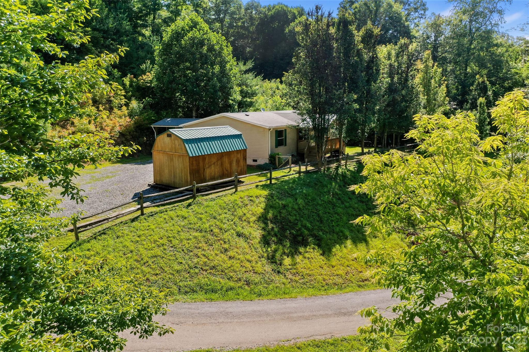 100 Lansing Road Waynesville, NC 28786 - Photo 4 of 11 an aerial view of a house with a yard basket ball court and outdoor seating
