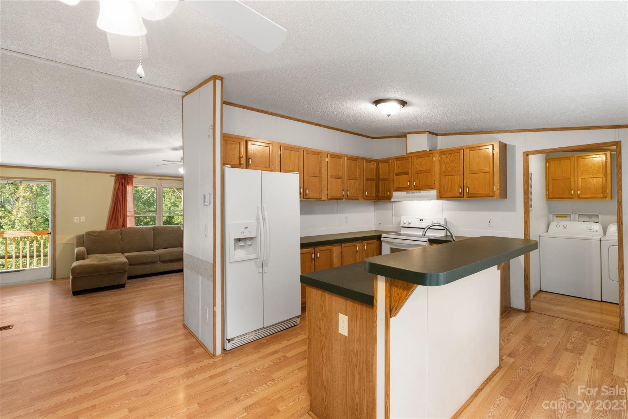 100 Lansing Road Waynesville, NC 28786 - Photo 6 of 11 a kitchen with granite countertop a refrigerator stove top oven and sink