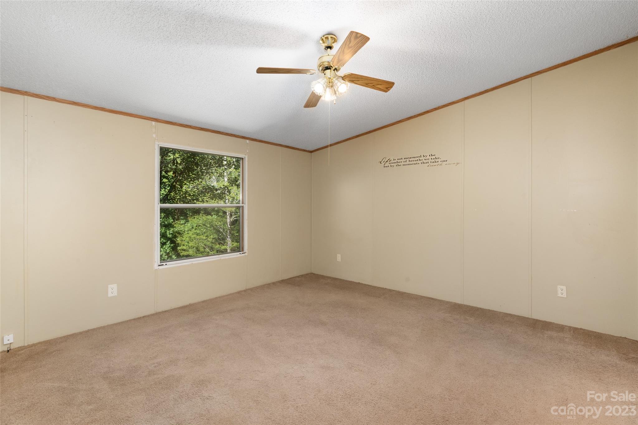 100 Lansing Road Waynesville, NC 28786 - Photo 8 of 11 an empty room with ceiling fan and window