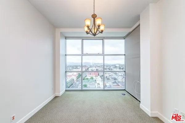 an empty room with windows city view