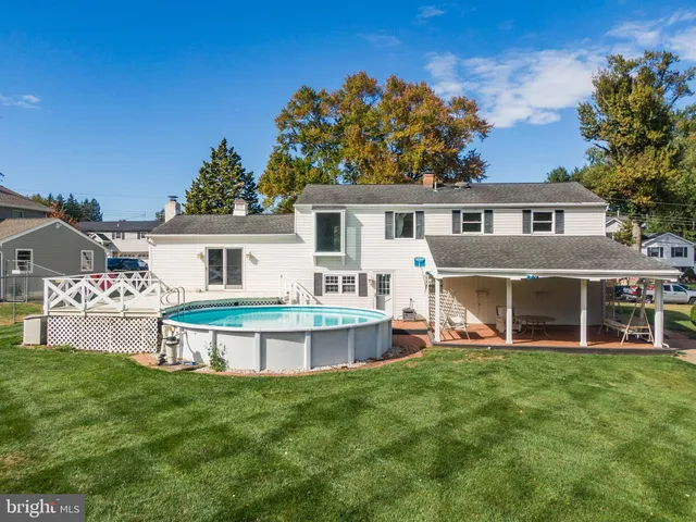 a view of a house with a backyard and a patio