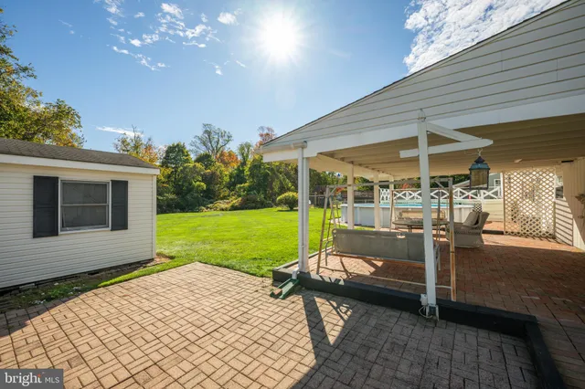 a view of a patio with a table chairs potted plants and a backyard