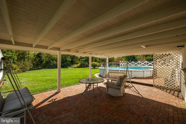 a view of a patio with table and chairs potted plants with garden view