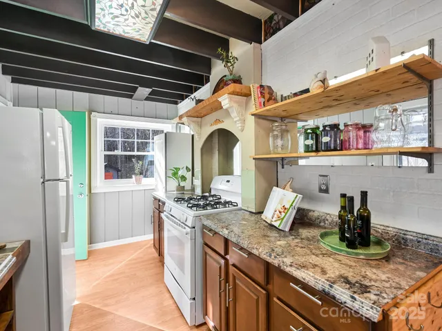 a kitchen with stainless steel appliances granite countertop a sink and a stove