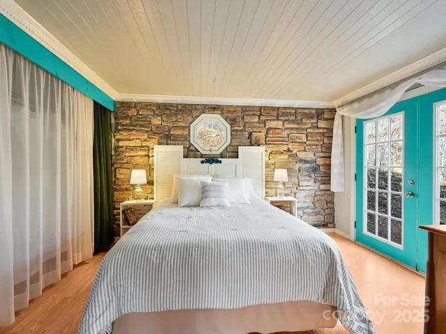 a bedroom with a large bed and a large window