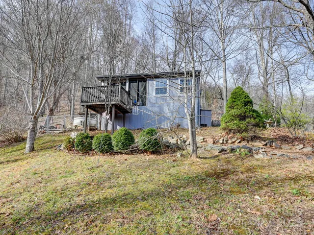 a front view of a house with a tree