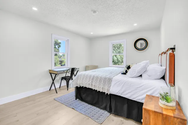 a bedroom with a bed and a window