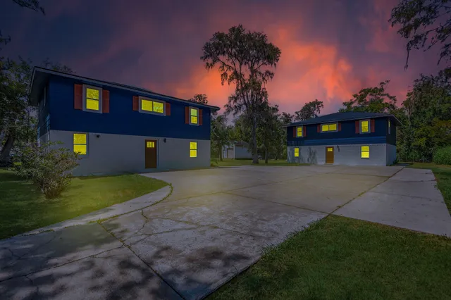 a front view of a house with a yard and a garage