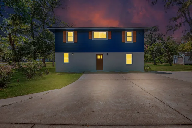 a front view of a building with a yard