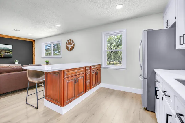 a view of a workspace with furniture and a kitchen