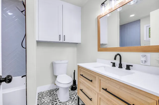 a bathroom with a sink toilet and shower
