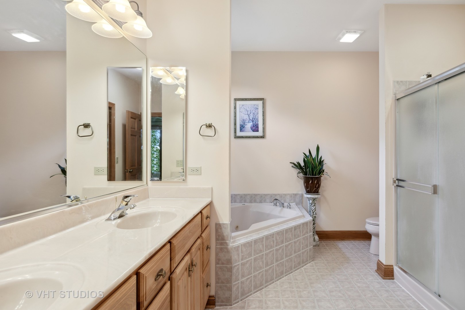 6 Olympic Court Lake In The Hills, IL 60156 - Photo 12 of 32 a bathroom with a tub sink and mirror