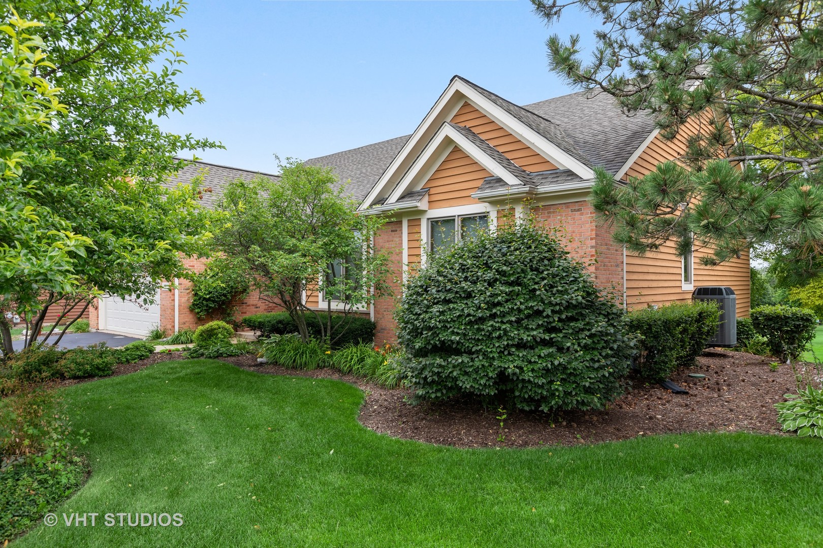 6 Olympic Court Lake In The Hills, IL 60156 - Photo 3 of 32 a front view of a house with a garden