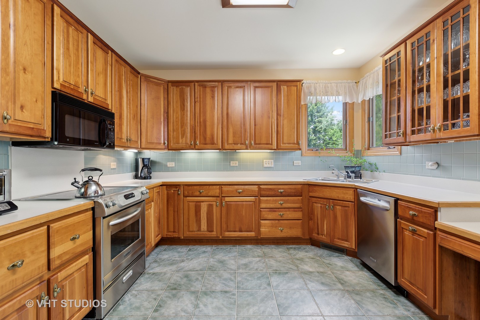 6 Olympic Court Lake In The Hills, IL 60156 - Photo 7 of 32 a kitchen with stainless steel appliances granite countertop wooden cabinets a stove top oven a sink and dishwasher