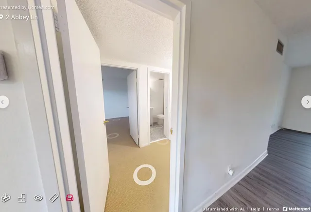 an empty room with windows and ceiling fan