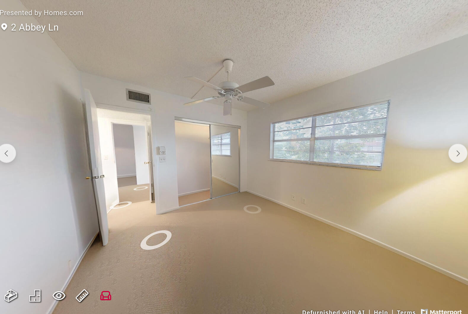 2 2 Abbey Lane, Unit 203 Delray Beach, FL 33446 - Photo 16 of 22 an empty room with windows and ceiling fan