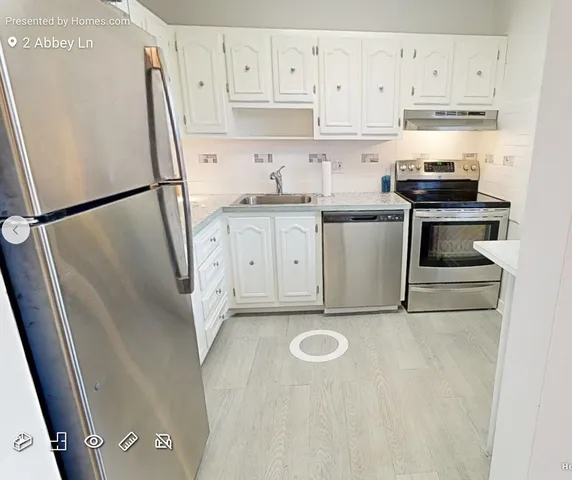 a kitchen with a sink a refrigerator and cabinets