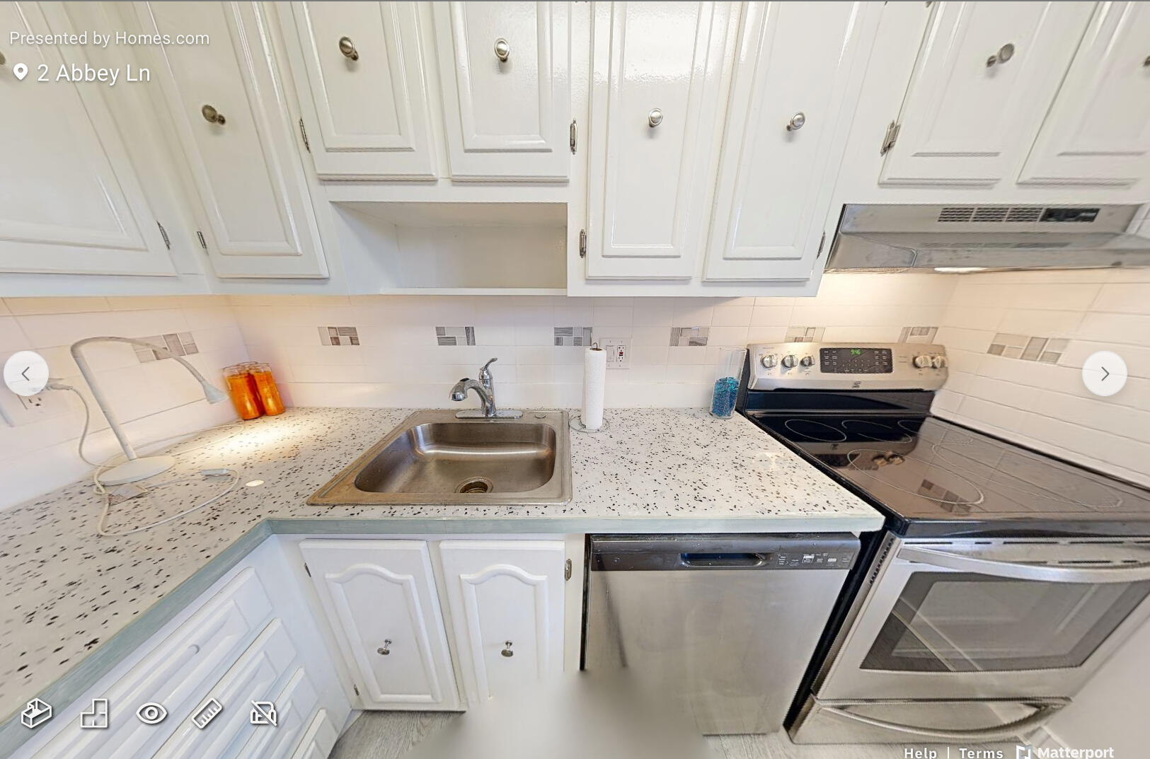 2 2 Abbey Lane, Unit 203 Delray Beach, FL 33446 - Photo 6 of 22 a kitchen with stainless steel appliances granite countertop a sink dishwasher and cabinets with wooden floor