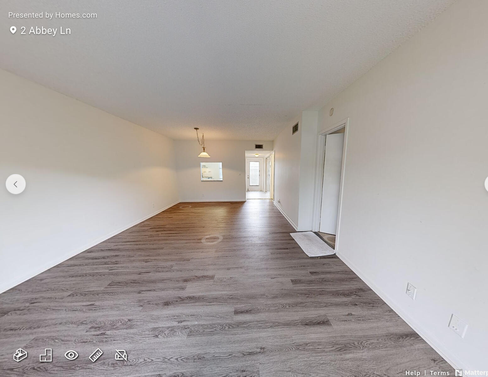 2 2 Abbey Lane, Unit 203 Delray Beach, FL 33446 - Photo 9 of 22 a view of an empty room with wooden floor