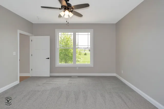 a view of room with window and ceiling fan
