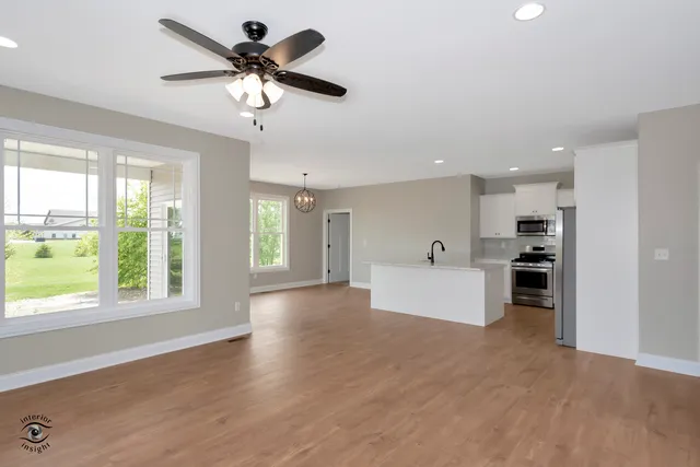 a view of a kitchen with furniture and a ceiling fan