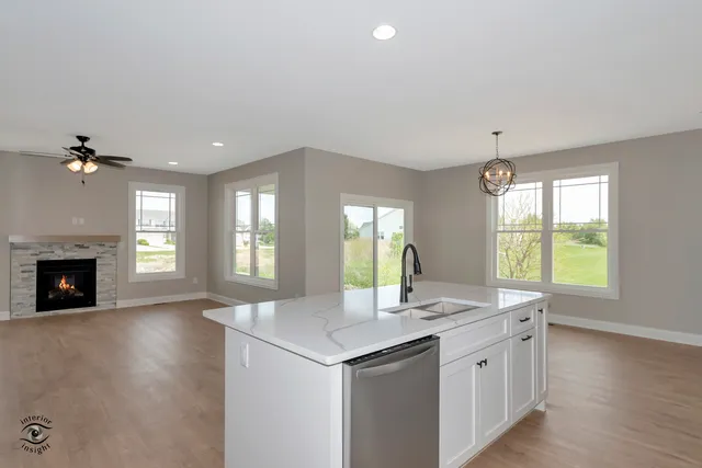 a view of kitchen with granite countertop cabinets table and chairs