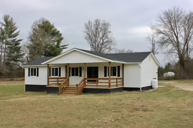a front view of a house with parking space