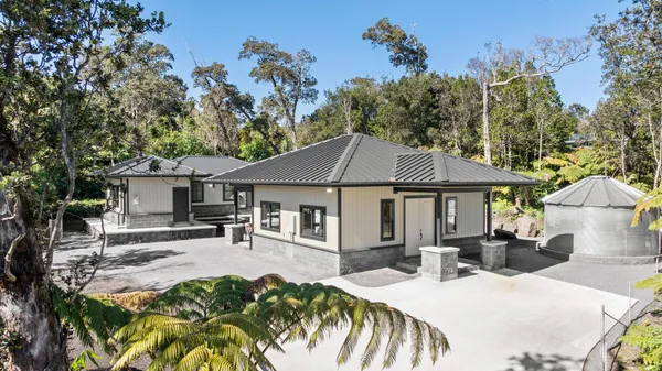a view of a house with backyard and sitting area