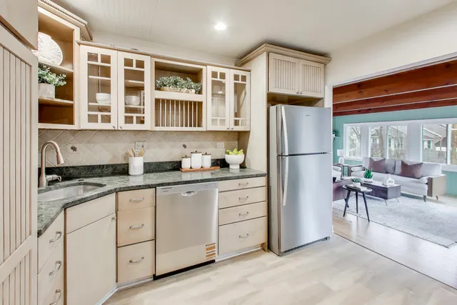 a kitchen with granite countertop cabinets and refrigerator
