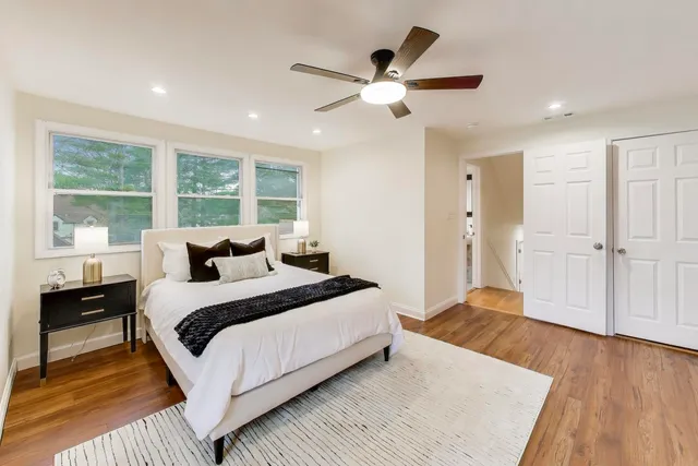 a bedroom with a large bed and a chandelier