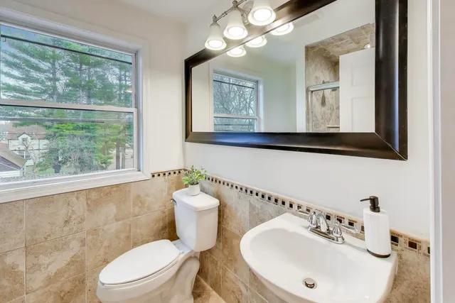a white toilet sitting next to a bathroom sink