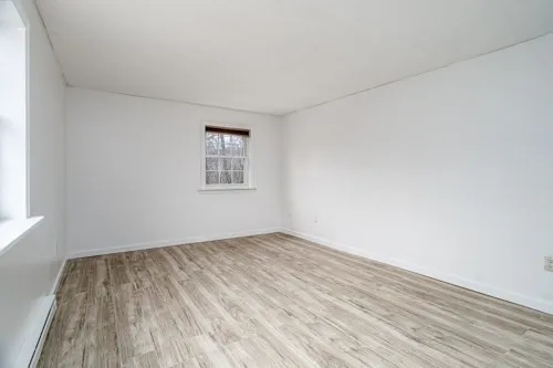 a view of a room with wooden floor